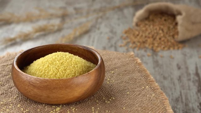Raw couscous on burlap rotating. Seamless loopable. 4K