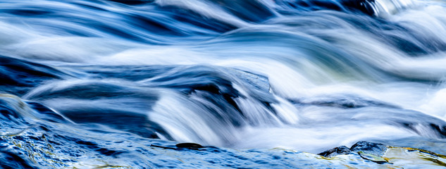 Waterfall into foamy river - Powered by Adobe