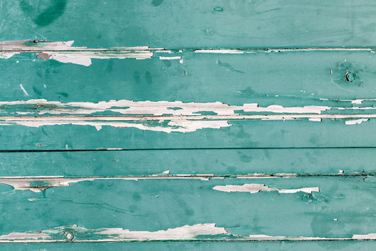 Texture of orizontal wood panels with old green paint peeling of