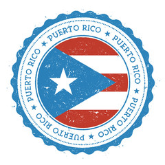 Grunge rubber stamp with Puerto Rico flag. Vintage travel stamp with circular text, stars and national flag inside it. Vector illustration.