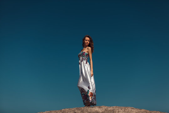 Beautiful Woman Over The Blue Sky