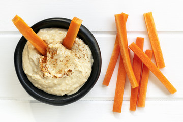 Hummus with Carrot Sticks Top View - obrazy, fototapety, plakaty