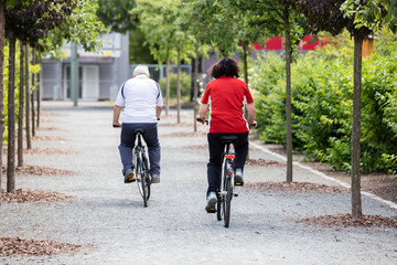 Couple Cycling In Park