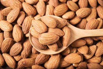 Almond in wooden spoon on table