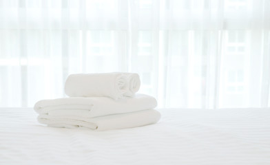 Fototapeta na wymiar white towel on white bed in bed room