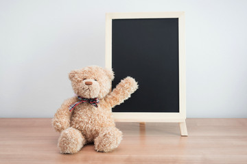 blank blackboard and teddy bear