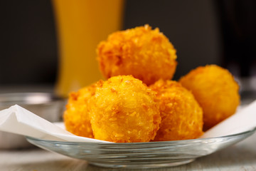 Lay the croquettes on a plate with red sauce. Big.