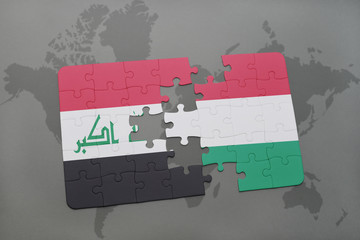 puzzle with the national flag of iraq and hungary on a world map background.