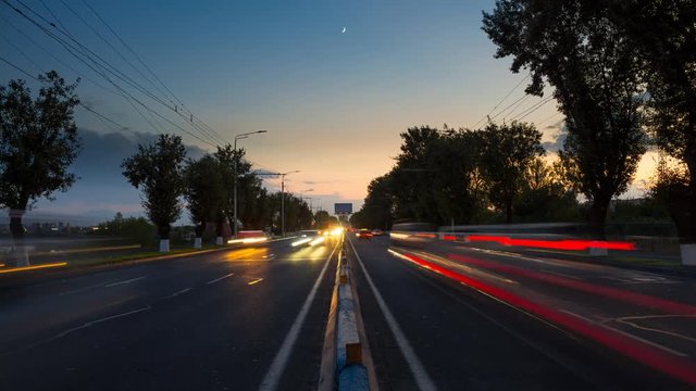 4K time lapse higway at night with motion blurred images on sunset background