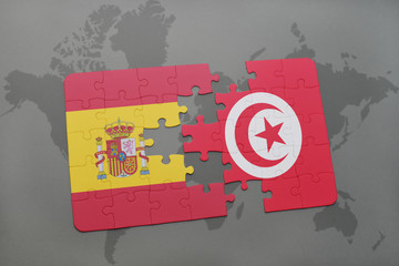 puzzle with the national flag of spain and tunisia on a world map background.