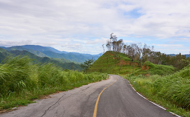 Alphas road and mountain range background in cloudy day. Roadside viewpoint, Chong Yen at Mea-Wong National Park,Thailand. Tropical rain-forest in asia