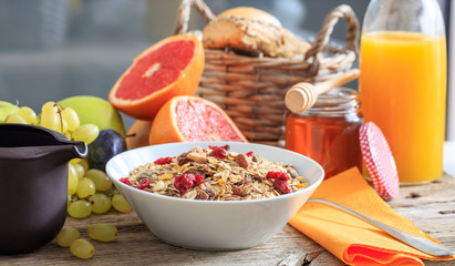 Healthy breakfast - Fresh fruits and cereal bowl on a wooden table