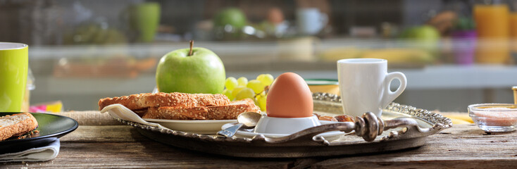Breakfast with fresh fruits, boiled egg and coffee