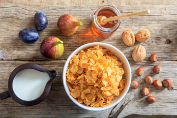 Healthy breakfast - Corn flakes, fresh fruits and nuts - top view