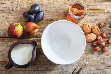 Breakfast - Empty bowl, fruits and nuts on a table