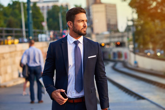 Young businessman in the tram stop