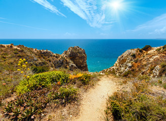 Sunshine above Atlantic rocky coastline (Algarve, Portugal).
