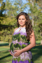 portrait of beautiful pregnant woman in park