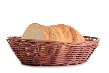 Pieces of bread in a wicker basket on white background