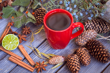 Christmas still life with red Cup of tea,pine cones ,cinnamon.