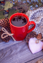 Christmas still life with red Cup of tea,pine cones ,cinnamon.