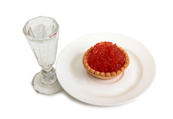 Fish caviar and glass of vodka on a white background
