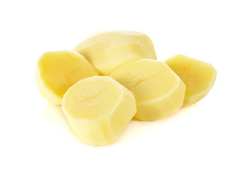portion cut peeled potato on white background