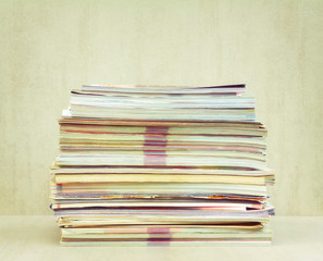 a big pile of magazines closeup, front view. tinted photo