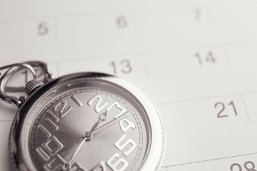 Old pocket watch on calendar page. vintage, black&white