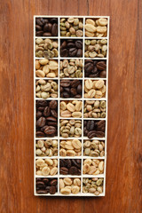 different coffee forms in wooden box on wooden background