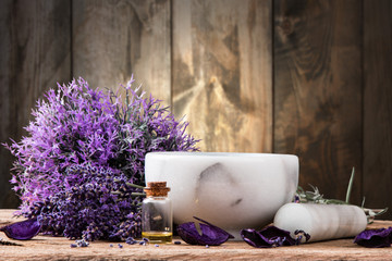 spa massage setting, lavender product, oil on wooden background