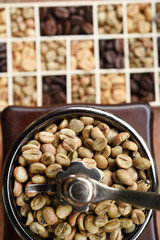 Coffee beans with coffee grinder on wooden background