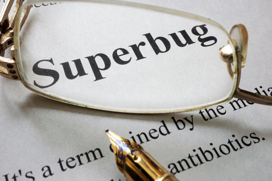 Paper with word superbug and glasses. Medical concept.