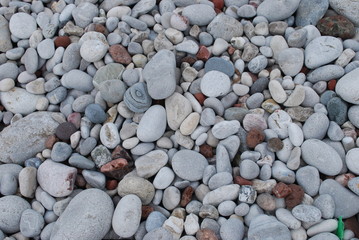 Red and grey natural pebble-stone on the beach. Background.
