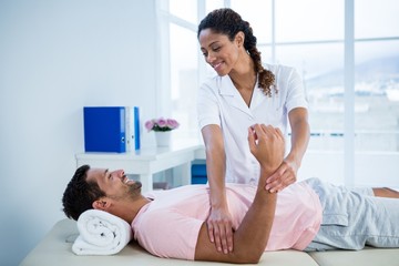 Fototapeta premium Physiotherapist giving hand massage to a patient