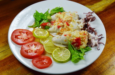 steamed squid stuffed minced pork dressing spicy lemon sauce on dish