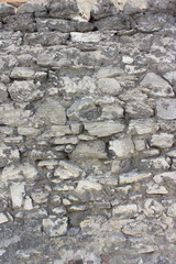 a fragment of a stone wall of an ancient monastery