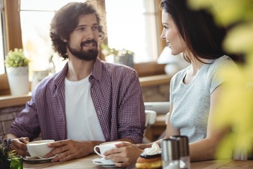 Couple interacting with each other while having coffee