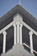 Building corner with triple supporting columns of white plaster finish.