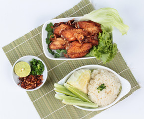 Sticky rice with fried chicken topped fried sliced red onion on bamboo and white. Top view.