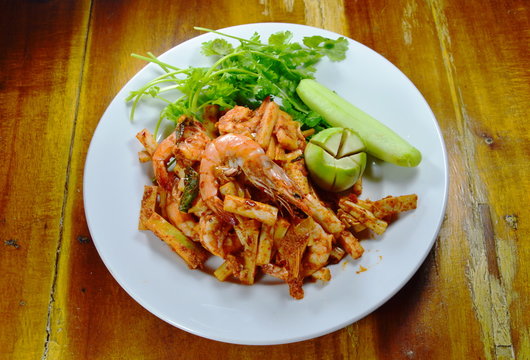 spicy stir fried shrimp with coconut shoot on dish