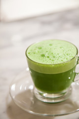 Green tea milk cup in glass put on the stone table.