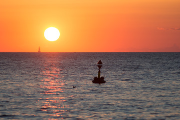 Fototapeta premium buoy floating in the sunset 
