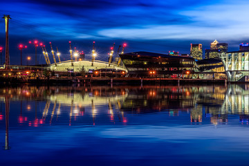 Fototapeta na wymiar The Crystal and the O2 arena seen from Royal Victoria Dock in London 