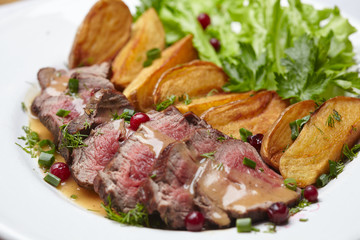 Tasty roasted pork meat with potatoes