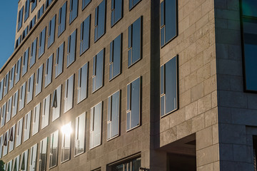 sun reflecting in windows of modern building
