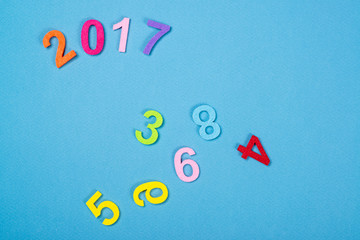 Close up of colorful number 2017 against wooden background.