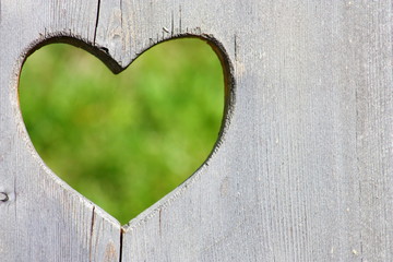 Wooden background with green heart