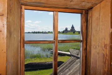 Kizhi pogost and Onega lake. View through the window from ancient wooden house