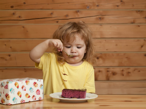Little boy eats fruit cake